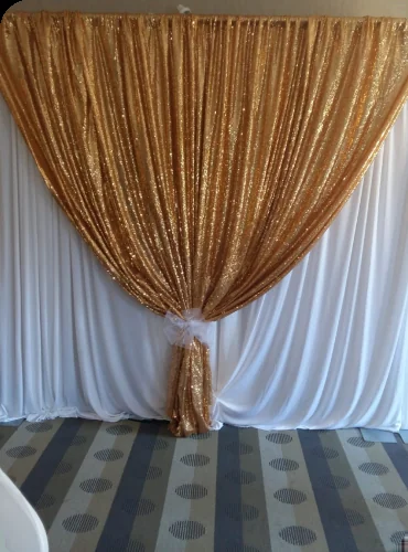 Gold sequin and white draped backdrop