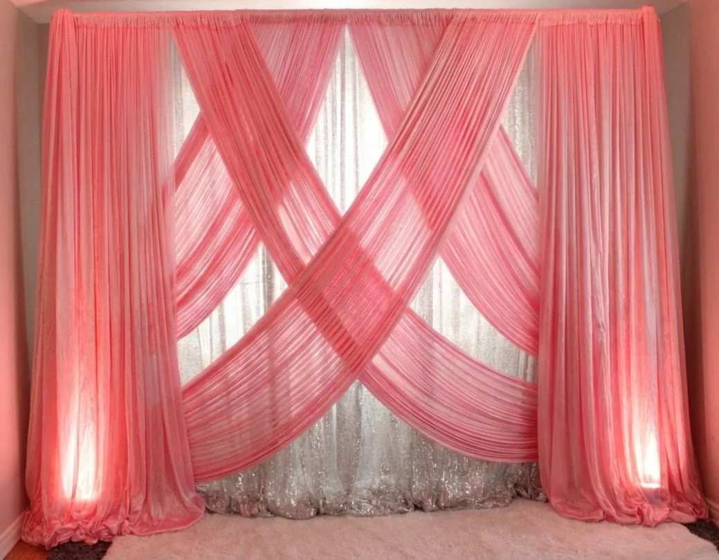 Pink and white draped wedding backdrop