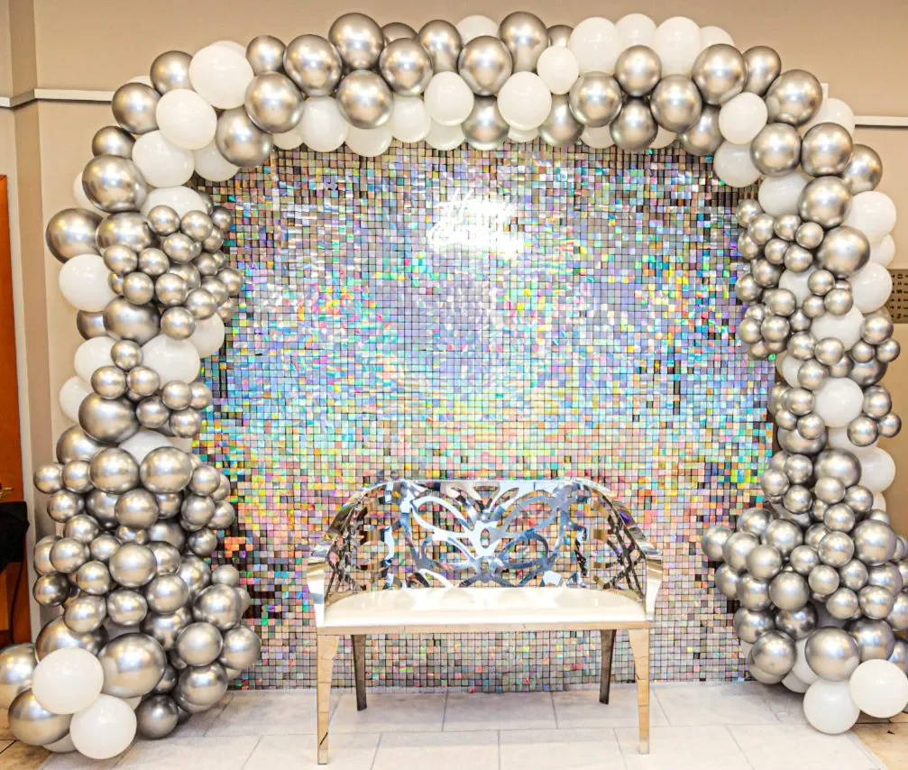 White balloon arch with shimmering backdrop