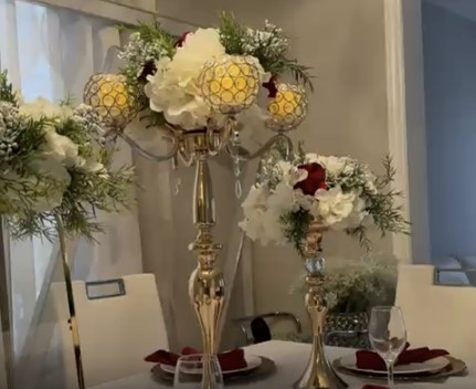 Gold candelabra centerpiece with white and burgundy florals
