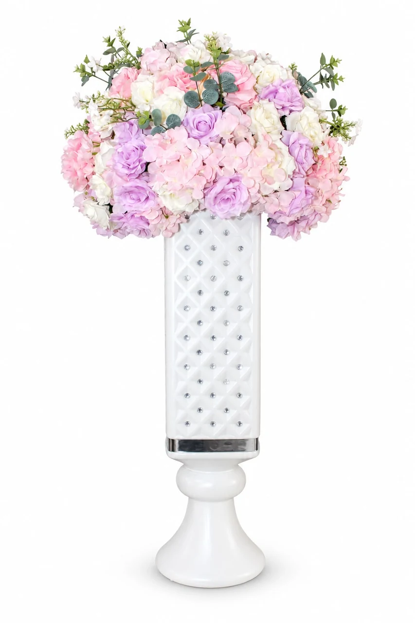 Pastel flowers in a white decorative pedestal vase