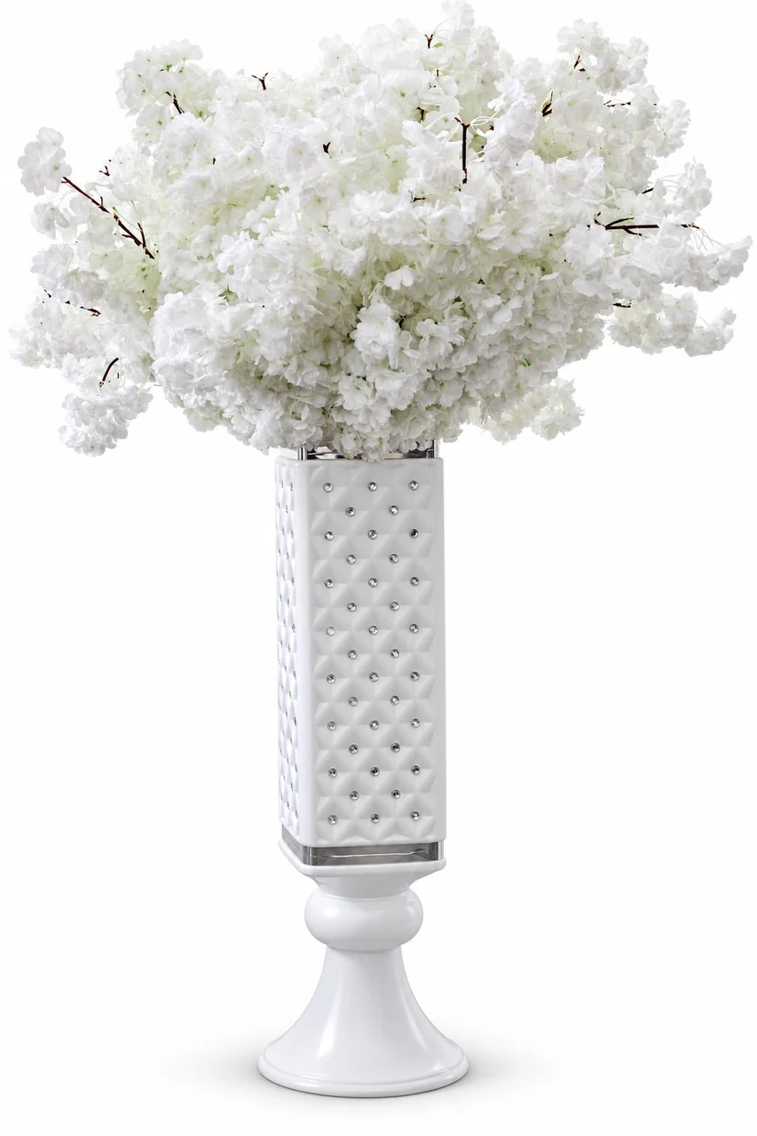 White blossom arrangement in a decorative pedestal vase