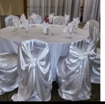 Table with draped silver chair covers and bows